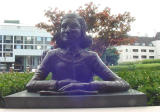 This is a bronze bust of Anne Frank with a book. This bust sits in front of the National Library. It is a bit deceptive in that this is a pretty small bust, yet the photo gives the illusion that it is life-size.