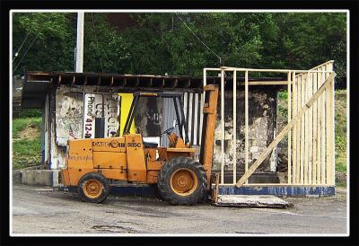 Iranian family begins to rebuild burned out gas station.