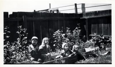 4 cousins in flower box:  Jim Wickwire, Barbara Bellinger, Bob Wickwire, and Dodie Bellinger, 1944 (218)