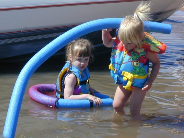 Taya and Kaelyn<br>play in the water