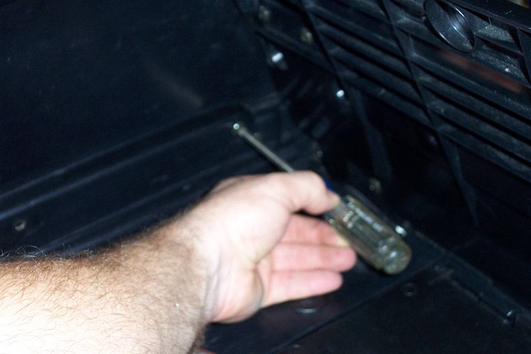 Remove the four screws in the trunk (two each side) that hold on the trim pieces
