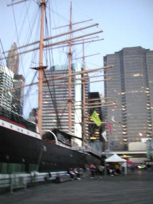 The Peking's masts are the first to emerge from the night as dawn breaks over Pier 17. Volunteers, having worked throughout the night, are well prepared for the hordes of cyclists that are about to arrive.