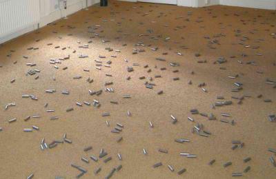 Inside a private house there was an exposition organised, steel parts on a carpet