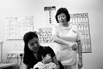 Community Nurse Assessing Infant's Hearing