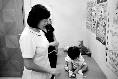 Community Nurse Assessing Infants Developmental Status