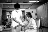 Nurse Bringing Elderly to Bed
