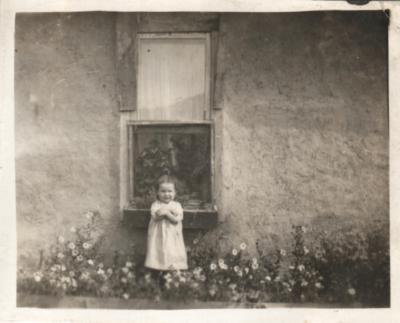 Pearl in front of the old mud house at Wood Mountain circa. 1920.