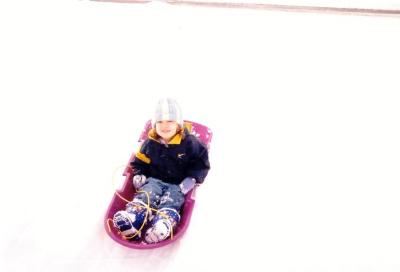 Sarah poses for a picture in her sled