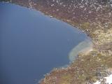 Birds eye view of solitary bird flying round Lochnagar Loch