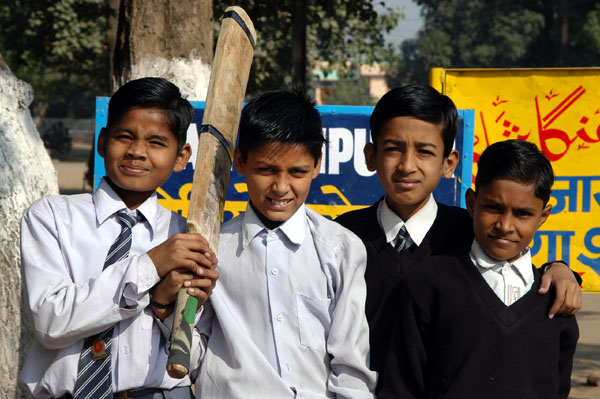 Schoolboys with a cricket bat