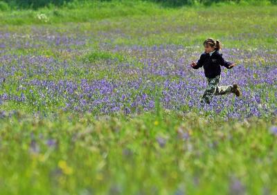 Girl Running in a Meadow