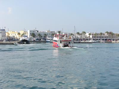 Day Trippers boat Capita' Jack preparing to berth bow-on at La Savina
Ferry 'Aigues de Formentera' can be seen alongside the jetty believed to be minus her starboard engine, hence listing to port
