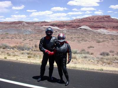 Ed and Judy stand on the roadside like two leather-clad aliens