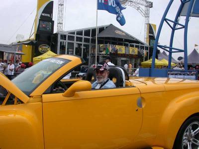 At the Chevy display, Ed tries on a Chevy SSR
