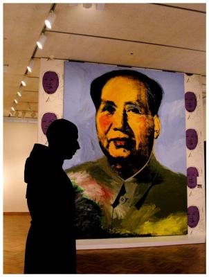 A statue in front of portrait of Chairman Mao, Chicago