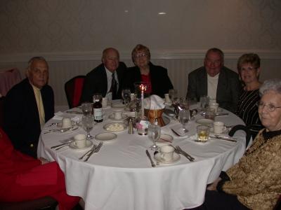 Dick Grim. George Phillips, and Paul Osterle with wives, Faye Happel on extreme right.