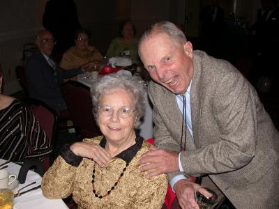 Norm and Faye Happel, Don Russell in background in dark suit.