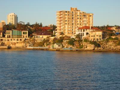 Manly skyline from ferry, saltwater pools at waters edge.