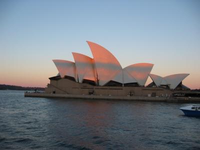 Sunset over Sydney. Shadow of Habour Bridge on Opera House.