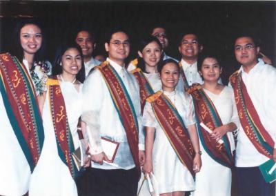 Graduates posing on stage
