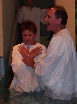 Alex was baptized, to show a public display of his confession and belief in Jesus.  This picture was taken while our pastor was asking him questions related to that decision.