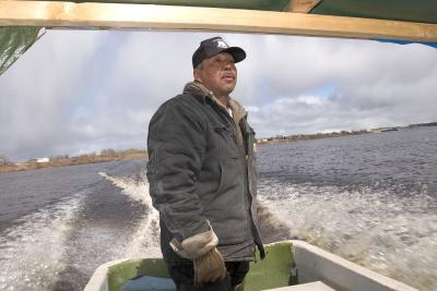 Boat taxi driver with Moosonee in the background