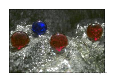8-star red and blue marbles in water on granite x3f