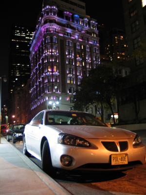 Pontiac Grand Prix and Purple Lit Fancy Building