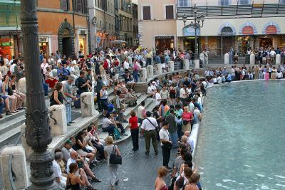 The evening crowds in front of the Trevi Fountain in Rome, Italy.