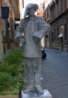 Stationary mime imitating statuary on Via Condotti in Rome.