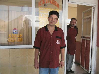 The name is also on his shirt.  I wonder if the window has the address, which includes an
'010' I think.  I'd like to send them photos if anyone from Turkey knows.