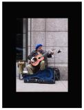 A street musician entertains with his electric guitar.