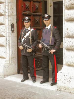 Greetings from Perugia!! Police with uzis & bullet proof vest in front of a bank (and throughout Italy). These guys are serious!
