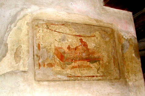Pompeii - An erotic fresco on the wall of the Lupanar (brothel) . The Lupanar was the official brothel of Pompeii.