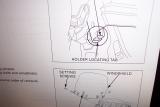 I think this diagram in the service manual has a mistake.  It shows the tab on the fairing should be ABOVE.
