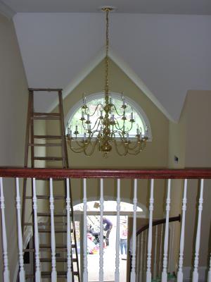The foyer chandelier as seen from the upstairs bridge