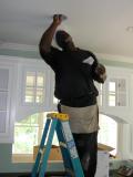 Another electrician wires the recessed lights