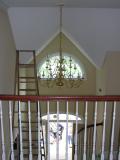 The foyer chandelier as seen from the upstairs bridge