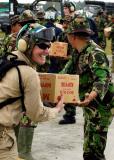 Indonesian Armed Forces personnel transfer supplies