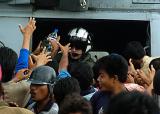 Indonesian citizens swarm an SH-60 Seahawk