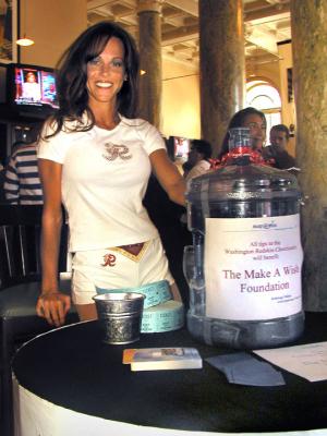 Arriving customers are greeted at the door by Washington Redskins Cheerleader Jackie, who takes donations for Make-A-Wish...