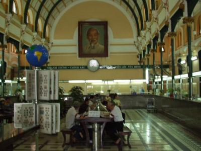 Inside the post office, watched over by Uncle Ho