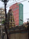 Hindu temple with pink and green hotel