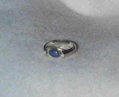 Small (6x8mm) denim lapis stone set in a horse-shoe style ring.
