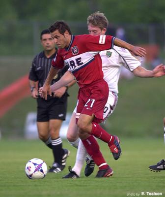 Dema battles Wolyniec at midfield.