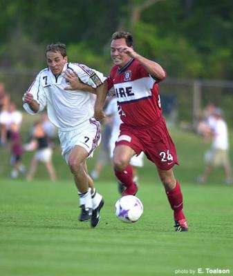 Moore shielding the ball from Bilyk.