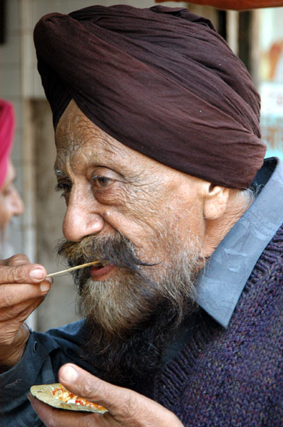 Old man eating, India