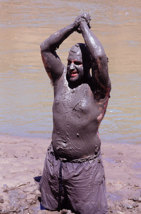 Mud man celebrates in dance.