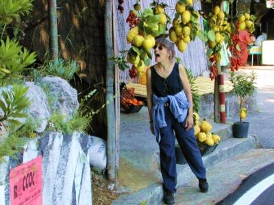 Judy tempted to sample a huge lemon on Amalfi Drive near the Hotel Marmorata