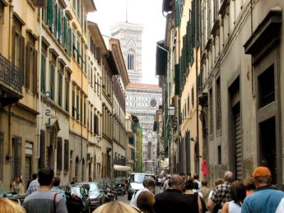 A street in Florence with the Duomo and Campanile (bell tower) in the background.